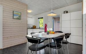 a kitchen and dining room with a table and chairs at Three-Bedroom Holiday Home In Ebeltoft in Ebeltoft