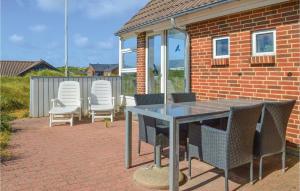 a table and chairs sitting on a brick patio at Holiday Home Ringkøbing With Fireplace Ii in Ringkøbing