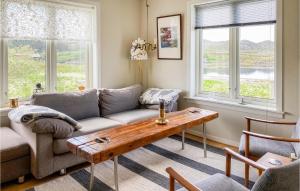 a living room with a couch and a table at Beach Front Home In Smøla With Kitchen in Smøla