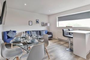 a dining room and living room with a table and chairs at Newly Renovated 3 Bed 2 Bath Apartment & Parking in Sheffield