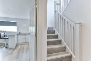 a white staircase in a room with a desk at Newly Renovated 3 Bed 2 Bath Apartment & Parking in Sheffield +25 photos