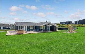 a house with a large yard with a playground at Lovely Home In Løkken With Sauna in Løkken