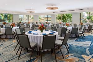 a conference room with long tables and chairs at OUTRIGGER Waikiki Paradise Hotel in Honolulu