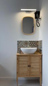 a bathroom with a sink and a mirror at Casa Cubana in Roubaix +12 photos
