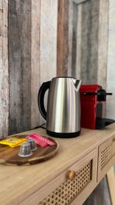 a metal tea kettle on top of a wooden table at Casa Cubana in Roubaix