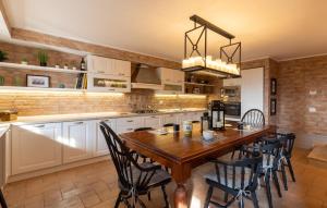 a kitchen with a wooden table and black chairs at Lovely Home In Castiglione Del Lago in Castiglione del Lago