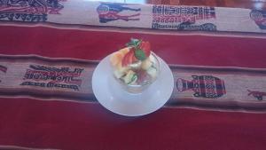 a white plate with a dessert on a table at Casa de Primo in Puno