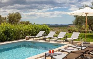 une piscine avec des chaises longues et un parasol dans l'établissement Villa Miramonti, à Sveti Lovreč Pazenatički