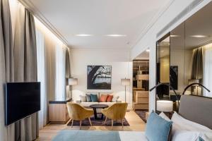 a hotel room with a bed and a living room at BoHo Prague Hotel - Small Luxury Hotels in Prague