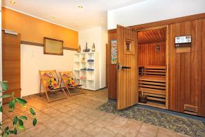 a room with a wooden door and a room with a table at Hotel Stecher in Oetz