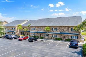 a large building with cars parked in a parking lot at 215 C2 GP-The Treehouse in Coffeyville