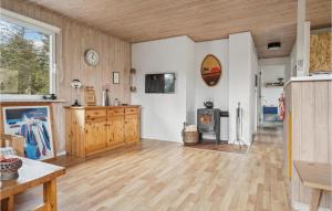 a large living room with a wood floor and a fireplace at Holiday Home Mølgårdsvej Thisted in Sønder Vorupør