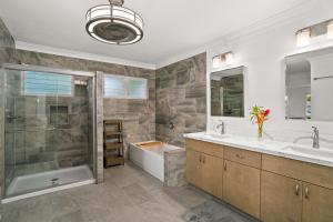 a bathroom with a tub and a sink and a shower at (3817) 4Br 4.5 Ba Punahele House with Ocean Views in Princeville +32 photos