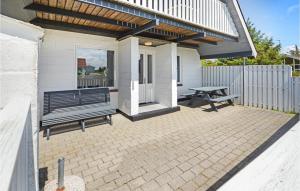 a patio with a bench and a picnic table at Holiday Home Fiskervej Thisted Iii in Nørre Vorupør