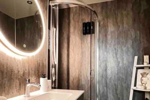 a bathroom with a sink and a shower with a mirror at 1-Bed Apartment Sleeps 2 -Free Parking -WiFi & Tv in Dundee +16 photos