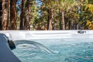 a pool with water coming out of it at Dream Moon House - Great Location, Hot Tub, Game Room, Pool Table, Air Hockey, Foosball in Big Bear City