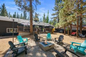 a group of chairs sitting around a fire pit at Dream Moon House - Great Location, Hot Tub, Game Room, Pool Table, Air Hockey, Foosball in Big Bear City