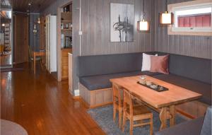 a living room with a couch and a table at Cozy Home In Noresund With Kitchen in Noresund