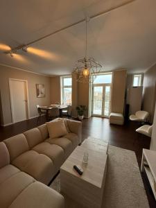 a living room with a couch and a table at Apartment Solsiden Trondheim in Trondheim