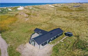 an overhead view of a house on a hill near the ocean at Four-Bedroom Holiday Home In Ringkobing in Ringkøbing +29 photos