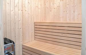 a sauna with wooden paneling on a wall at Four-Bedroom Holiday Home In Ringkobing in Ringkøbing