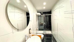a bathroom with a mirror and a sink at Palazzo Goyze in Naples
