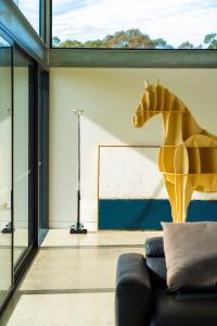 a living room with a statue of a horse on the wall at Mountain Top Bilpin, Long House Isyd in Bilpin