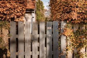 a fence in front of a house with leaves at St Leonard's Luxury Lodge, St Andrews in St. Andrews +25 photos
