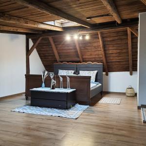 two beds in a room with wooden ceilings at Apartament wiejska chata 150m2 in Piece