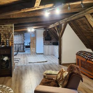 a living room with a couch and a kitchen at Apartament wiejska chata 150m2 in Piece +41 photos