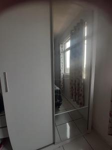 a mirror in a room with a window at Apartamento Inteiro Foz do Iguaçu Prox Rodoviaria in Foz do Iguaçu +1 photo