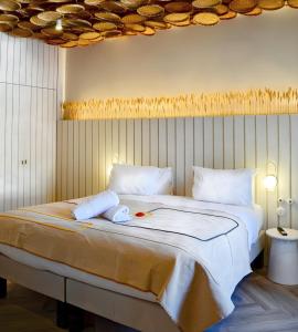 a bedroom with a large bed with two towels on it at Hotel M Soleil - Montpellier Centre Saint Roch in Montpellier +123 photos