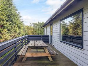 a picnic table on the deck of a house at 8 person holiday home in Otterup-By Traum in Otterup
