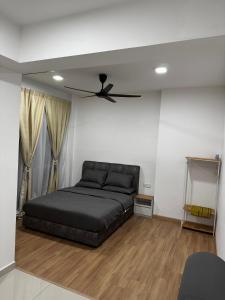 a bedroom with a bed and a ceiling fan at Amani Staycation Bandar Seri Alam#Studio in Masai