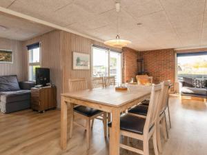a dining room with a wooden table and chairs at 8 person holiday home in Otterup-By Traum in Otterup