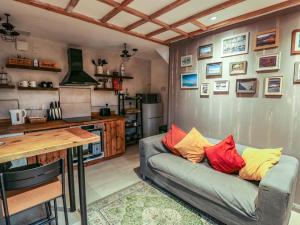 a living room with a couch and a kitchen at 1 Dinas cottages in Caernarfon