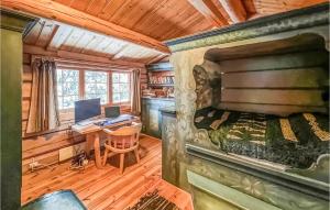 a bedroom in a log cabin with a bed and a desk at Stunning Home In Kvam With Wifi in Kvam