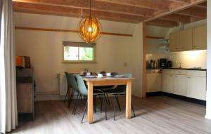 a kitchen with a table and chairs in a room at Hawar in De Bult