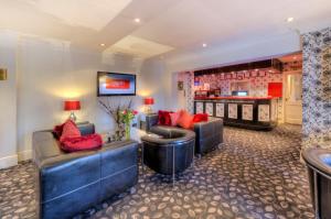 a living room with two couches and a bar at Flexistay Reading West Aparthotel - With Communal Kitchen Use in Reading