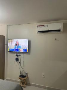 a flat screen tv on a wall in a bedroom at Residencial bella vista haus in Cabedelo
