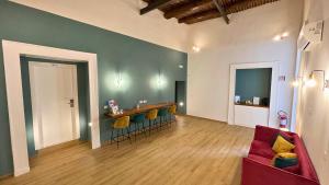 a living room with a red couch and a table at Palazzo Goyze in Naples +28 photos