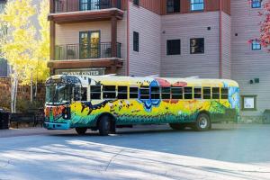 a colorful bus parked in front of a building at Perfect Location Outdoor Pool and Hot Tub 273 in Crested Butte