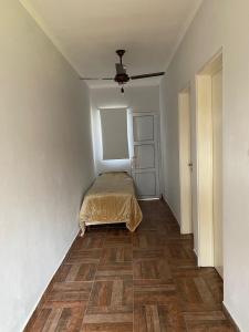 a bedroom with a bed in the corner of a room at El Despertar in Concepción del Uruguay