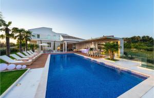 a swimming pool in the backyard of a house at Villa Petra Pag in Borovići