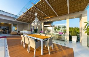 an open kitchen and dining room with a table and chairs at Villa Petra Pag in Borovići