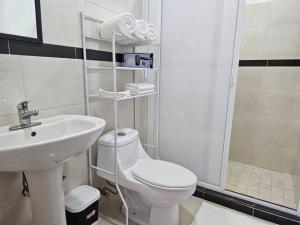 a bathroom with a white toilet and a sink at Mono Espacio en Zona Romántica L3 in Puerto Vallarta +17 photos
