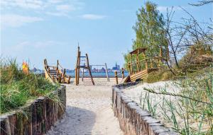 a playground on the beach with a fence at Ferienwohnung Altefähr in Altefähr