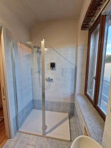 a bathroom with a shower with a glass door at Il Gufetto in San Maurizio Canavese