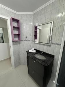 a bathroom with a sink and a mirror at Apartamento 01suite e um quarto in Balneário Camboriú +17 photos