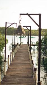 a wooden boardwalk leading into the water at Flow Guest House in Salinópolis